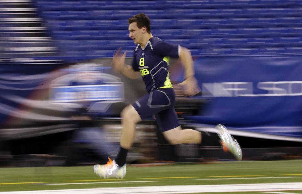 Texas A&M quarterback Johnny Manziel runs the 40-yard dash at the NFL football scouting combine in Indianapolis, Sunday, Feb. 23, 2014. (AP Photo/Michael Conroy)
