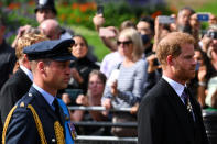 <p>Britain's Prince William, Prince of Wales (L) and Britain's Prince Harry, Duke of Sussex walk behind the coffin of Queen Elizabeth II, adorned with a Royal Standard and the Imperial State Crown and pulled by a Gun Carriage of The King's Troop Royal Horse Artillery, during a procession from Buckingham Palace to the Palace of Westminster, in London on September 14, 2022. SEBASTIEN BOZON/Pool via REUTERS</p> 