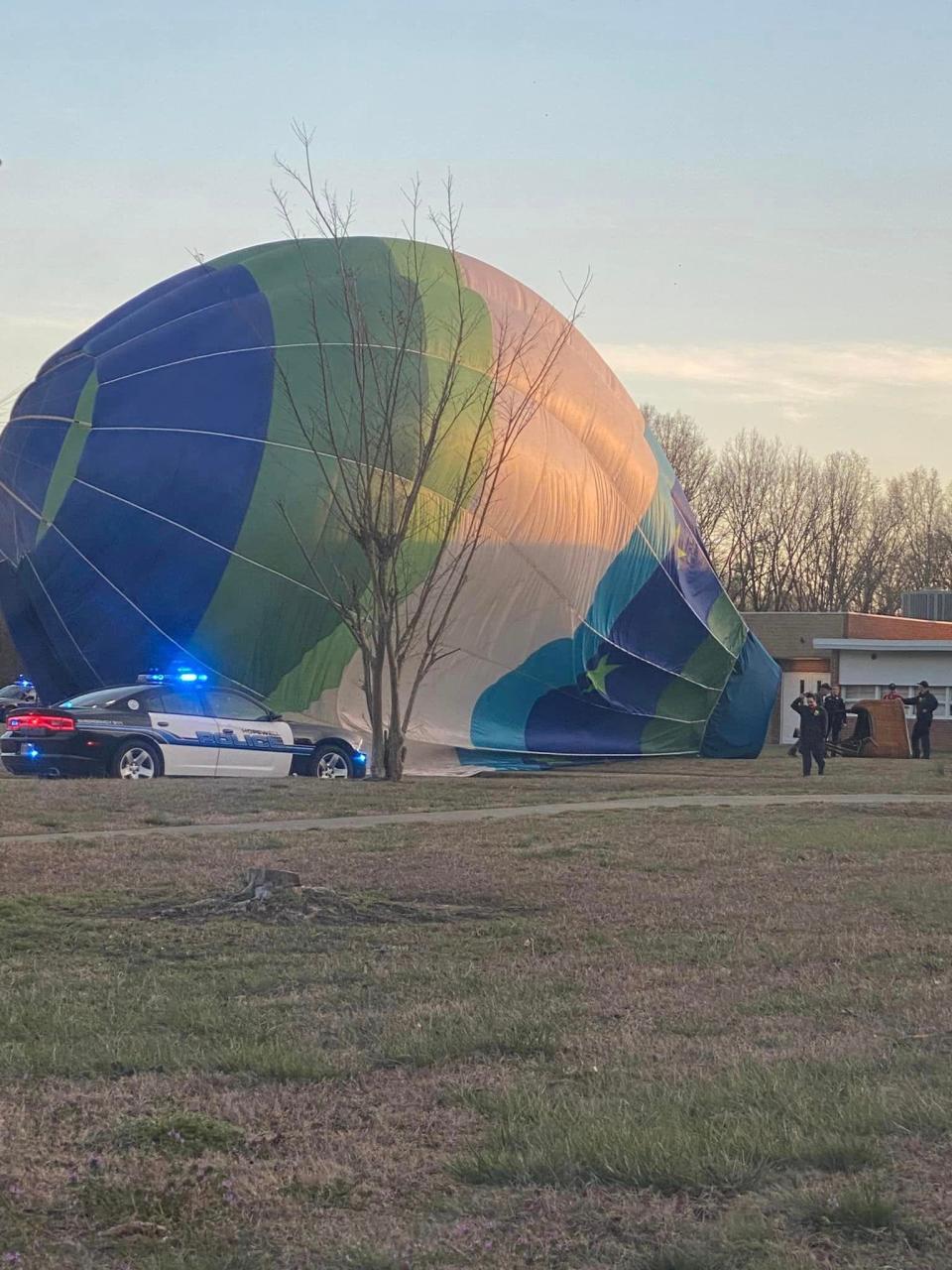 Emergency personnel assist in the deflation of a hot-air balloon Sunday, March 5, 2023 at Carter G. Woodson Middle School in Hopewell. The balloon was forced to make an emergency landing at the school. Fortunately, no one on the ride or on the ground was injured, and the scene was cleared in less than 15 minutes.