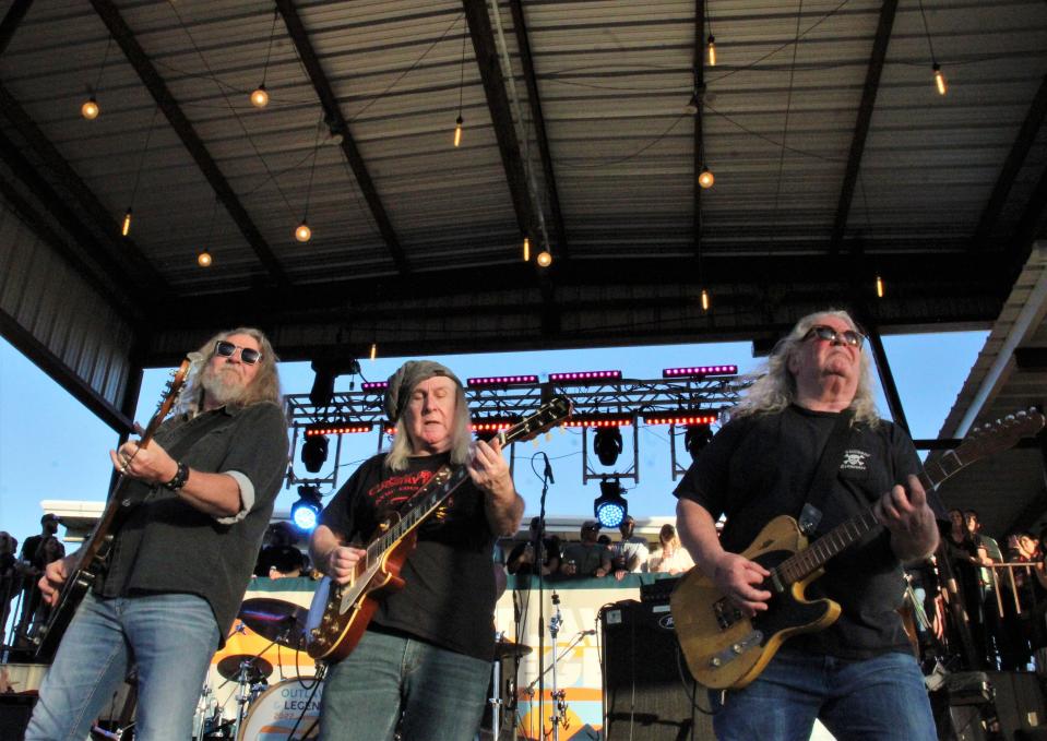 Kentucky Headhunters, from left, Doug Phelps, Greg Martin and Richard Young, rock away during their Friday show at the Outlaws & Legends Music Festival. March 25 2022