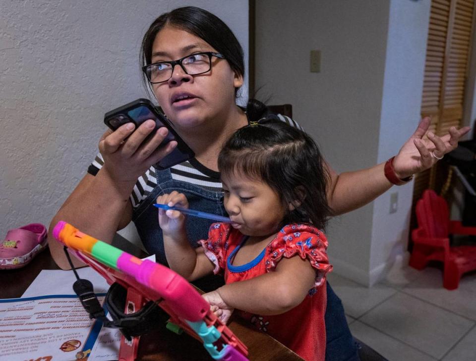Homestead, Florida - June 1, 2023 - With her daughter Joy playing on her lap, Elcira Morales makes calls to state elected official who voted for SB 1718 to voice her opposition to the new law.
