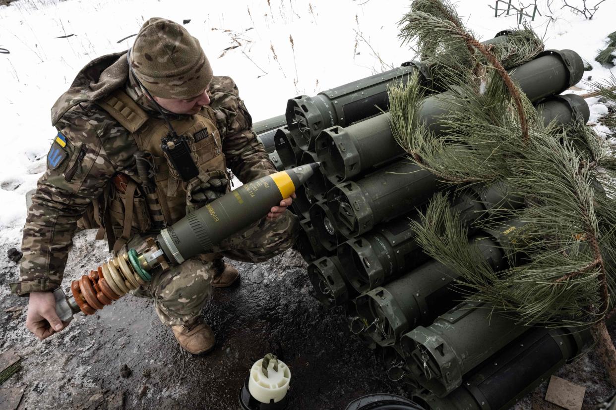 A Ukrainian serviceman of the 93rd brigade unloads a shell from a case (AFP via Getty Images)