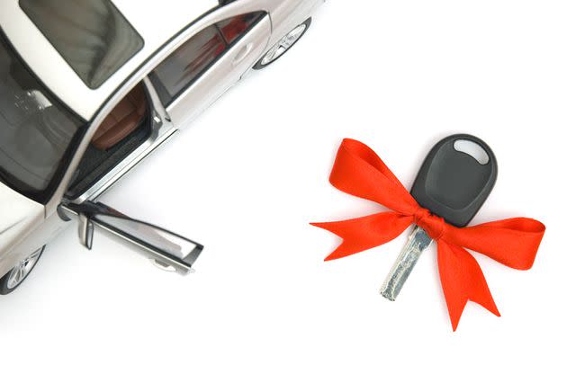 AquaColor / Getty Images Stock image of keys to a new car with a bow