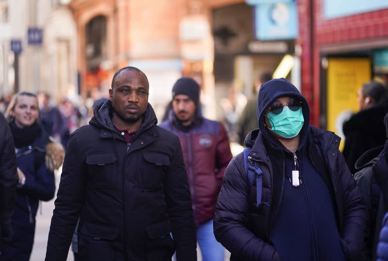 A person wears a protective face mask in central London