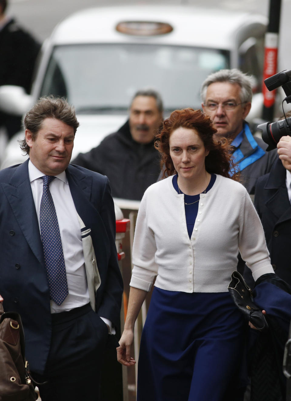 Rebekah Brooks, right, former News International chief executive, and her husband Charlie Brooks, left, arrive at the Central Criminal Court in London where she appears to face charges related to phone hacking, Thursday, Feb. 20, 2014. (AP Photo/Lefteris Pitarakis)