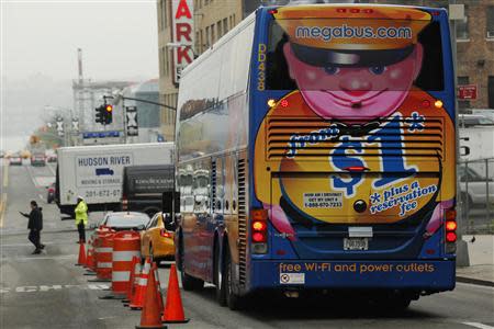 A Megabus bus makes its way through the streets in New York City May 8, 2014. REUTERS/Eduardo Munoz