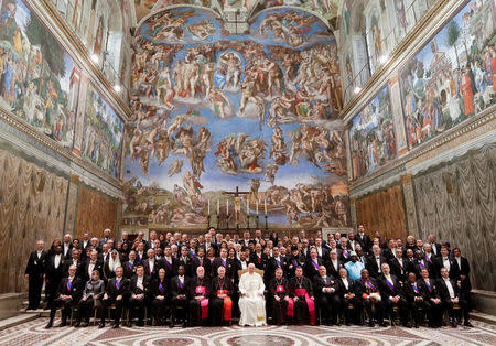 Pope Francis poses with diplomats at the end of the traditional exchange of the New Year greetings in the Sistine Chapel at the Vatican January 8, 2018. REUTERS/Andrew Medichini/Pool