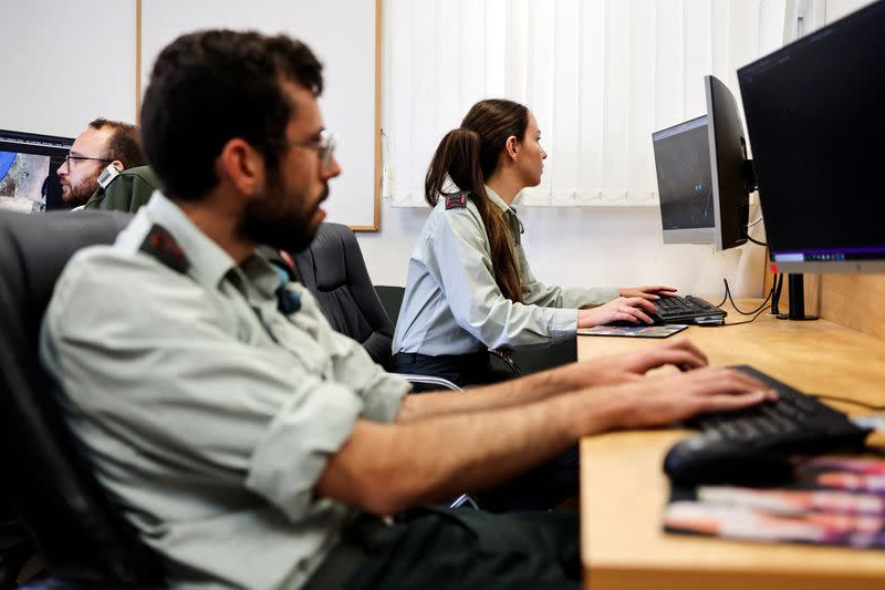 Technologists with the Israeli military's Matzpen operational data and applications unit work at their stations at an IDF base in Ramat Gan