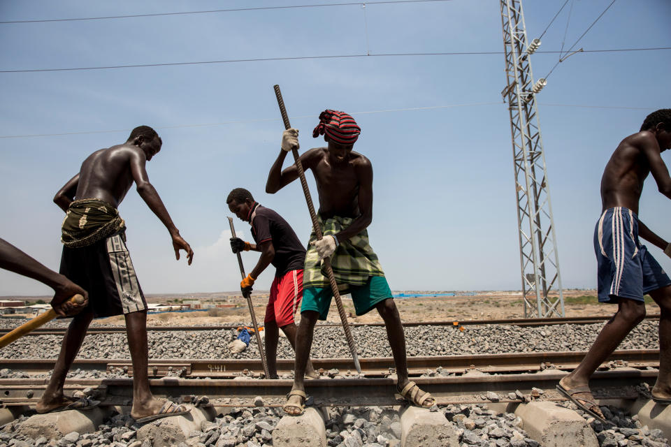 Workers maintain and check the Addis Ababa-Djibouti railway during a trial run in Addis Ababa, Ethiopia, on Sept. 28, 2016. Days later, after four years of construction and funding by the Chinese, it opened to become Africa's first cross-border electric railway.