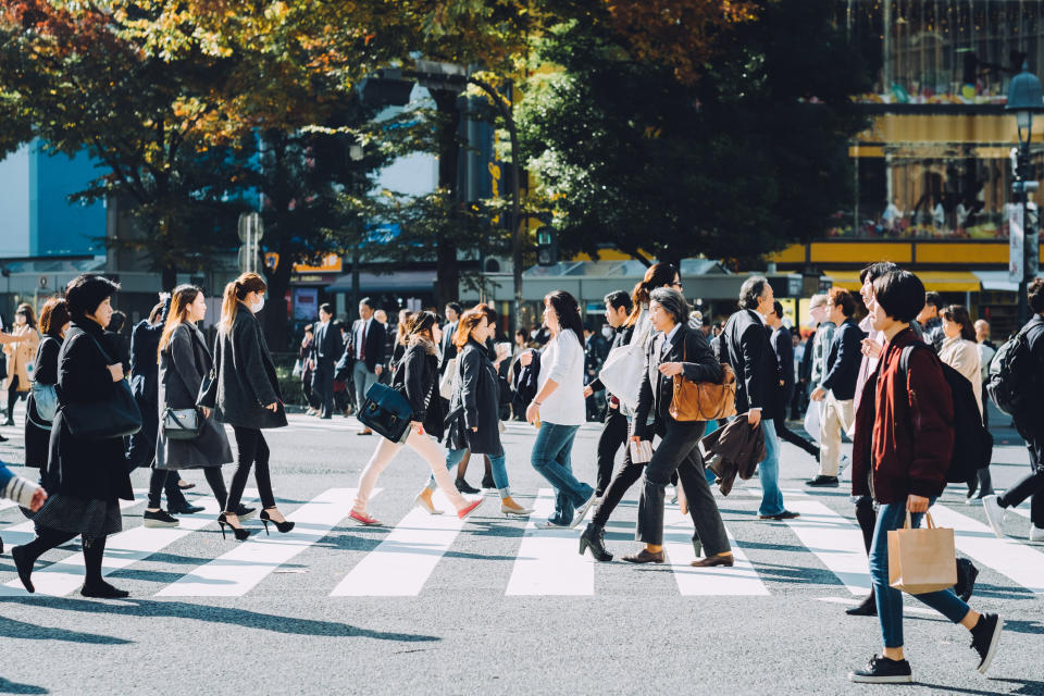 Japanese workers crossing a busy intersection in Tokyo