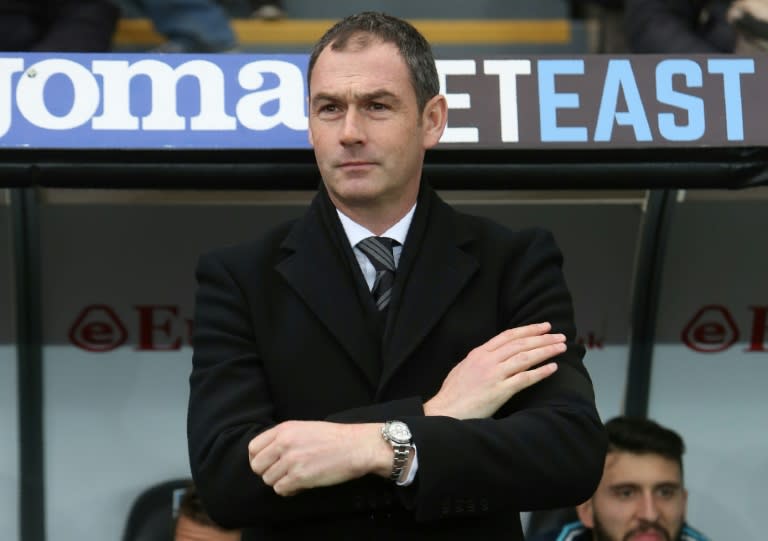 Swansea City's manager Paul Clement stands in the dugout ahead of their English Premier League match against Arsenal, at The Liberty Stadium in Swansea, on January 14, 2017