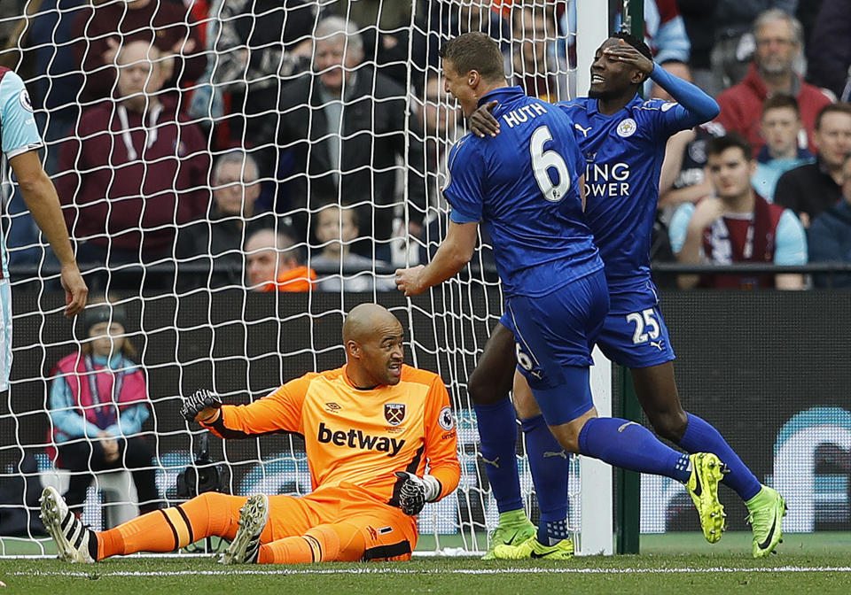 <p>Leicester’s Robert Huth, center, celebrates after scoring his side’s second goal of the game, during the English Premier League soccer match between West Ham and Leicester City at London Stadium in London, Saturday, March 18, 2017. (AP Photo/Frank Augstein) </p>