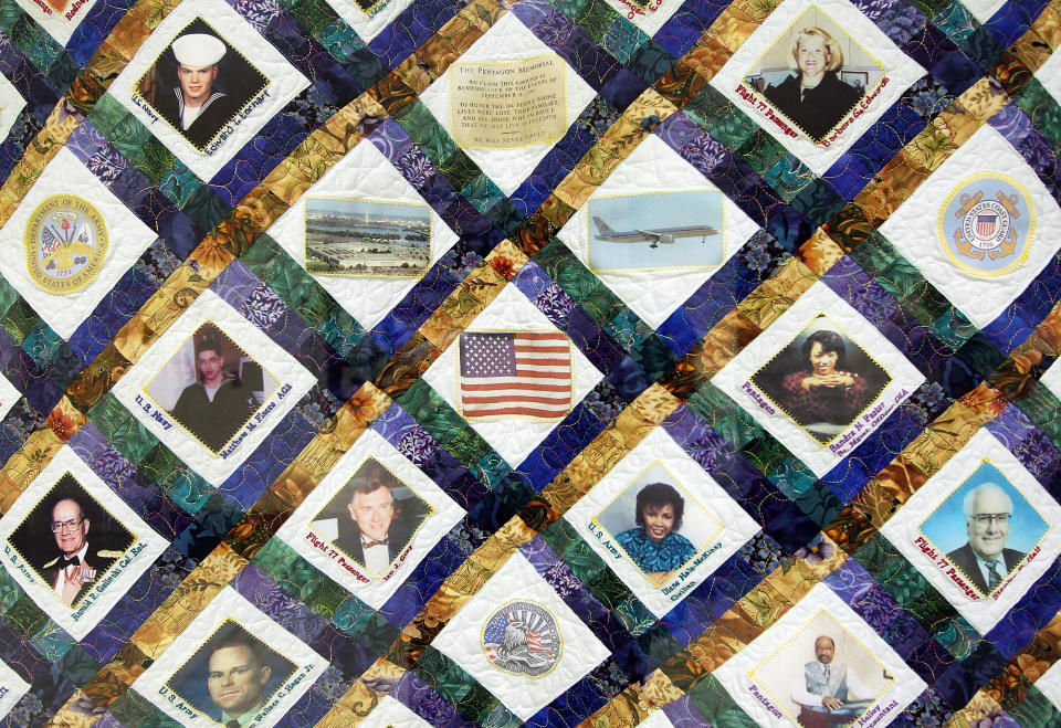 ARLINGTON, VA - JUNE 28: A quilt that features the victims of the Pentagon attack hangs on a wall of the Pentagon Memorial Quilts Corridor where 21 quilts, of more than 100 in the collection that serve as a historical record of the tragic events of 9/11, are on display June 28, 2011 in Arlington, Virginia. This year is the 10th anniversary of the September 11 terrorist attacks, in which 184 people were killed at the Pentagon. (Photo by Alex Wong/Getty Images)