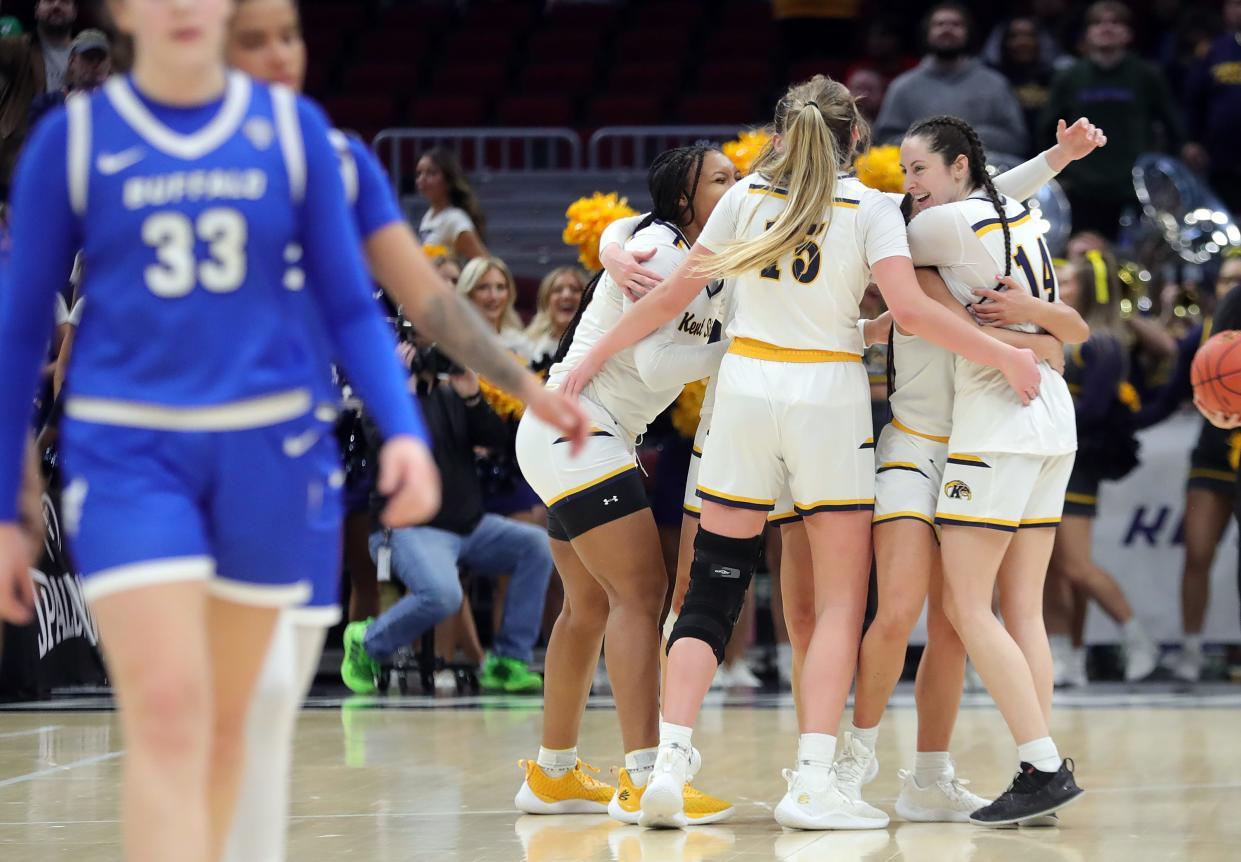 Kent State guard Katie Shumate (14) celebrates on the court with her teammates as time expires in the Mid-American Conference Women's Basketball Tournament championship game against Buffalo.