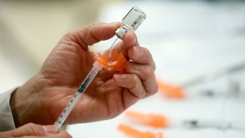 A Salt Lake County Health Department employee prepares Pfizer COVID-19 booster shots at a free vaccine clinic at the Sanderson Community Center in Taylorsville on Nov. 9, 2022. Americans who want an additional updated COVID-19 booster shot this spring got the final go-ahead Wednesday from the Centers for Disease Control and Prevention.