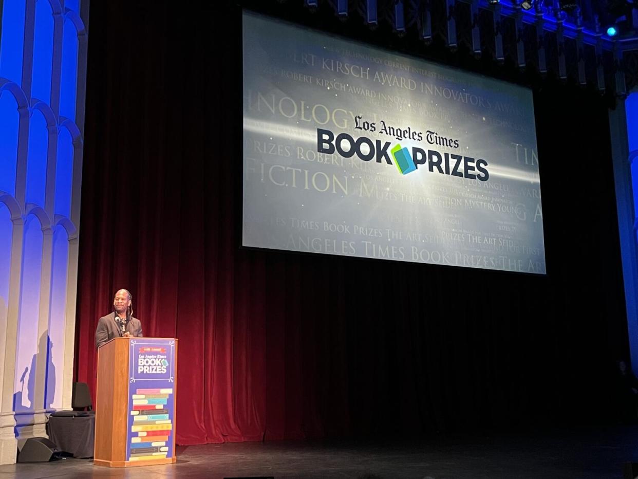 LZ Granderson stands at a lectern backed by a giant screen that says "Los Angeles Times Book Prizes."