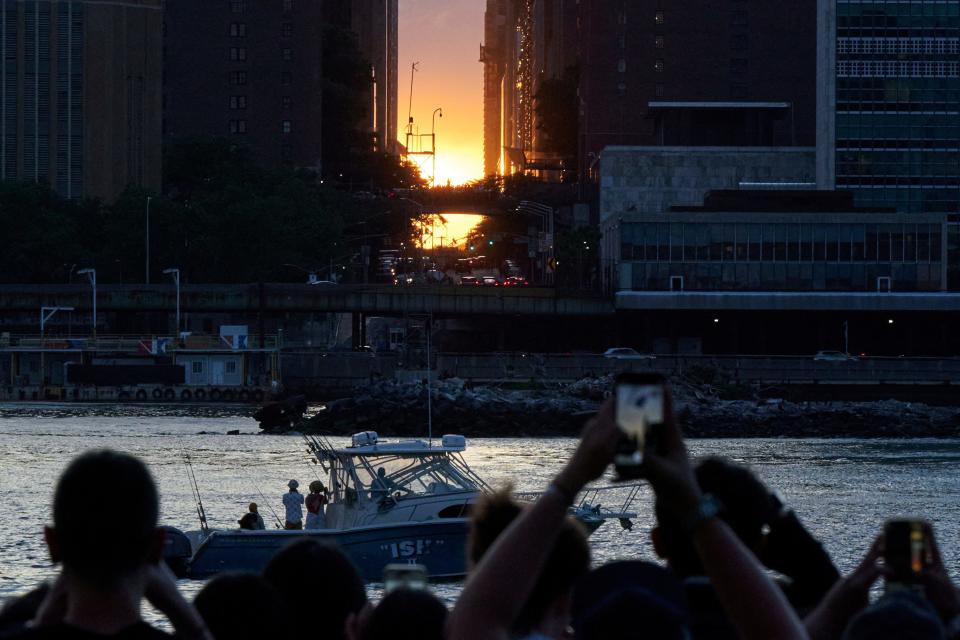 People gather to watch the sunset during a phenomenon known as Manhattanhenge, when the sun lines up with the Manhattan street grid, in Long Island City in the Queens borough of New York City, U.S., May 28, 2024.