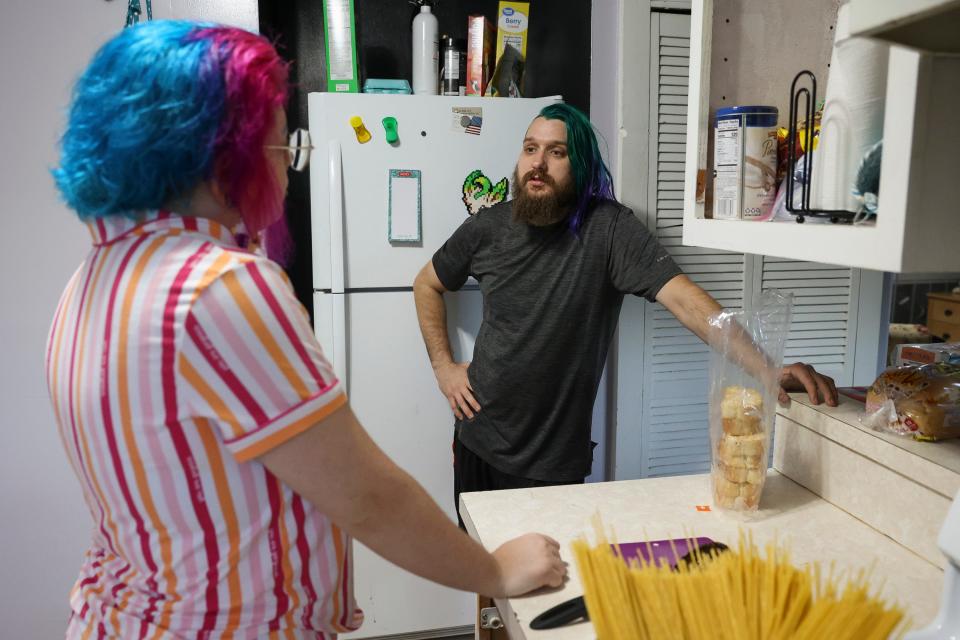 Tyler Simmons (right), 30, and his fiance Judas Rose, 24, talk in the kitchen while dinner is being prepared, Friday, Aug. 18, 2023, in Fort Pierce. They bought the fixer-upper home in April.