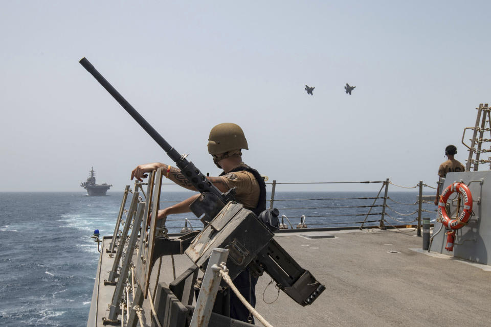 In this photo released by the U.S. Navy, two U.S. Air Force F-35A Lightning II fighter jets fly alongside amphibious assault ship USS Bataan and guided-missile destroyer USS Thomas Hudner in the Gulf of Oman, Thursday, Aug. 17, 2023. The Bataan transited through the Strait of Hormuz, the narrow mouth of the Persian Gulf, in recent days amid tensions with Iran, U.S. Navy Cmdr. Rick Chernitzer said Sunday, Aug. 20, 2023. (U.S. Navy via AP)