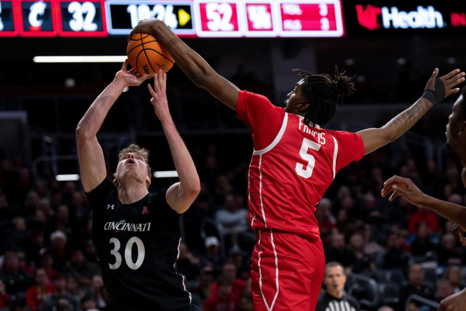 Cincinnati Bearcats forward Viktor Lakhin (30) draws a foul from Houston Cougars forward Ja'Vier Francis (5) Jan. 8. Houston won the game 72-59. UC will try to even the score Saturday in Houston.