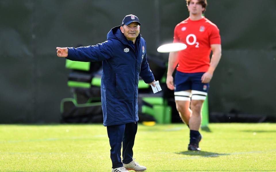 England head coach Eddie Jones plays with a frisbee during the training session at The Lensbury Hotel - PA