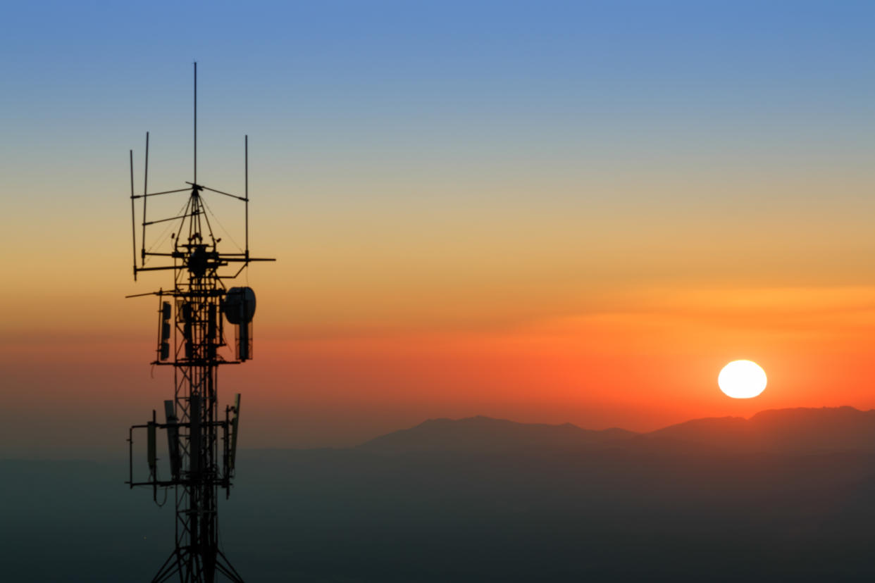 Communication tower backlit at sunset. With mountain range in the background. In the Sierra Nevada National Park, province of Granada, Spain.