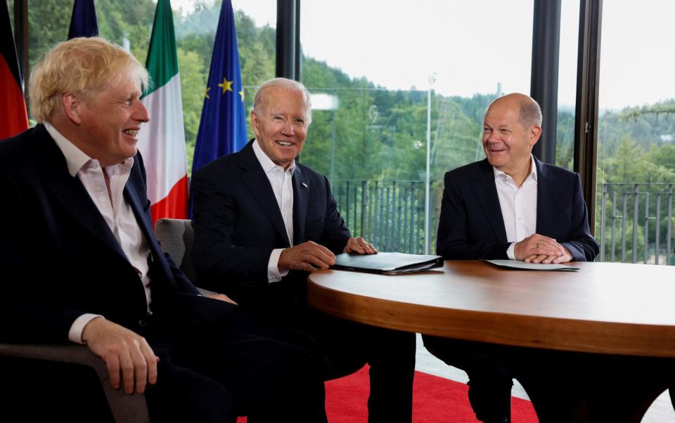 Boris Johnson sits next to US President Joe Biden and German Chancellor Olaf Scholz during a meeting at the G7 summit - JONATHAN ERNST 