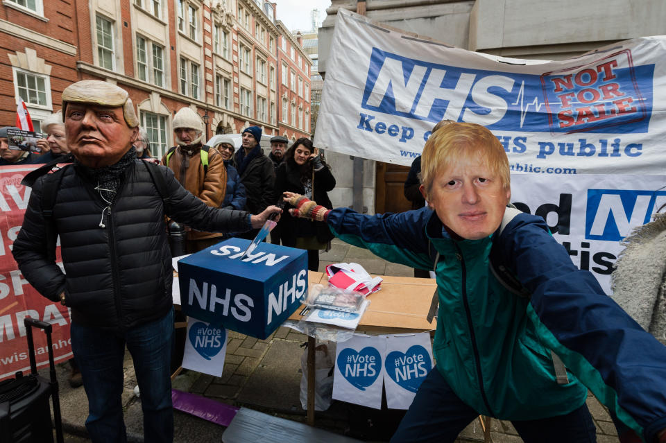 Demonstrators wearing masks of Donald Trump and Boris Johnson take part in a protest for keeping the National Health Service (NHS) publicly owned outside the Conservative Party HQ before marching to Downing Street with a petition, signed by over 1 million people, demanding that the NHS is excluded from any post-Brexit trade deals on December 09, 2019 in London, England. Photo: Getty