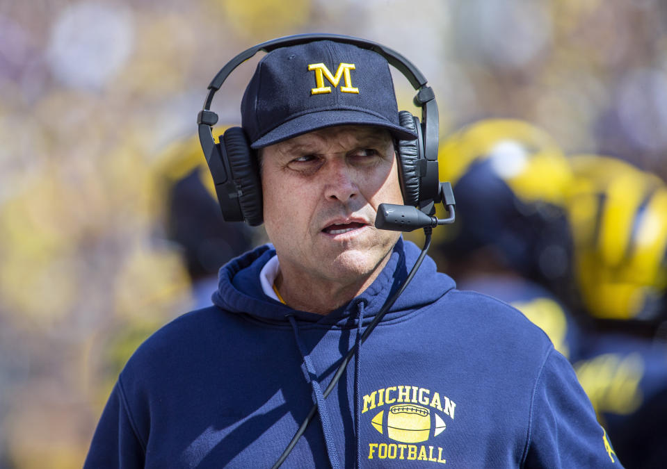 FILE - In this Saturday, Sept. 7, 2019. file photo,Michigan head coach Jim Harbaugh wears his headset on the sidelines in the first quarter of an NCAA football game against Army in Ann Arbor, Mich. Michigan is heading into the first really big Big Ten game of the season. The Wolverines face No.  13 Wisconsin in Madison on Saturday, Sept. 21, 2019.  (AP Photo/Tony Ding, File)