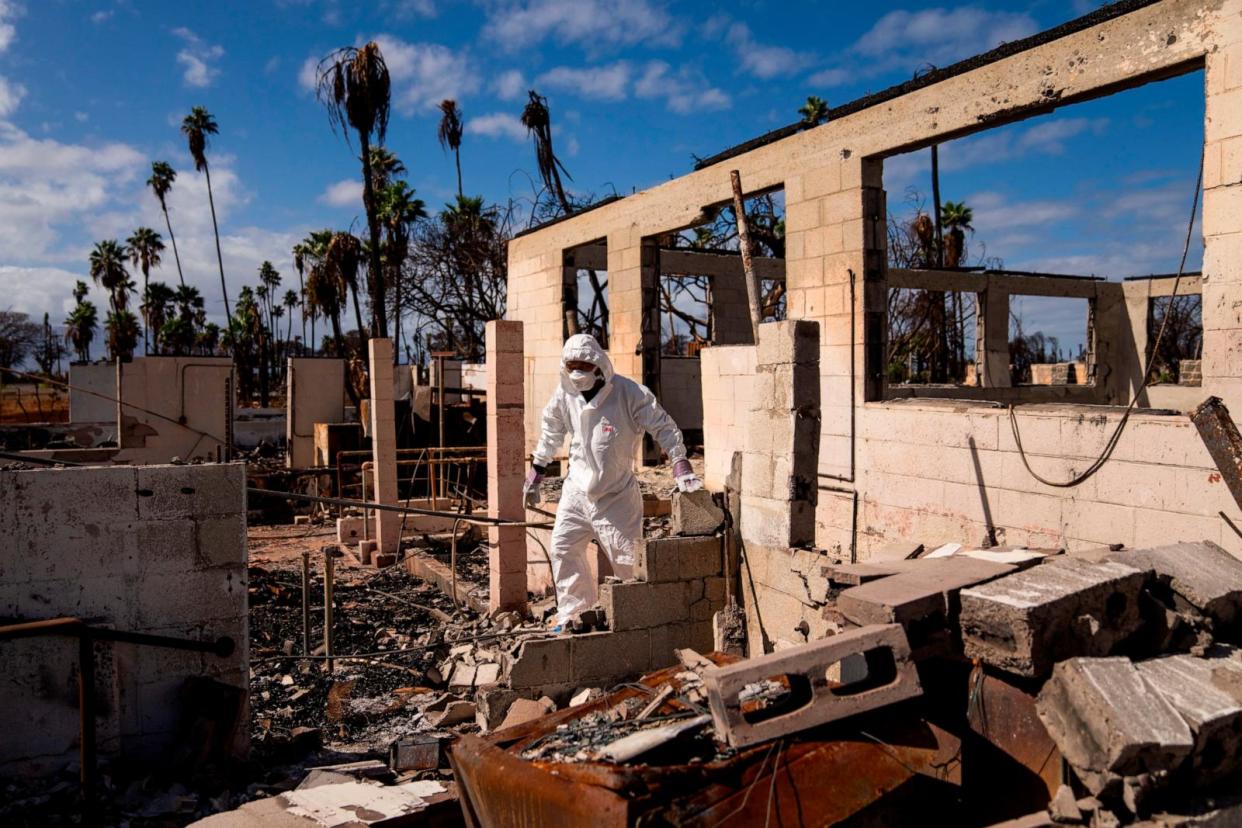 PHOTO: The Rev. Ai Hironaka, resident minister of the Lahaina Hongwanji Mission, walks through the grounds of his temple and residence destroyed by wildfire, Dec. 7, 2023, in Lahaina, Hawaii. (Lindsey Wasson/AP)