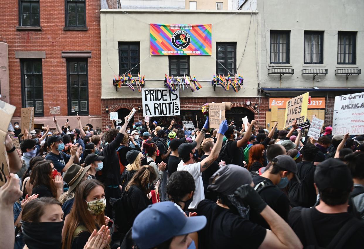 Protesters demonstrate past the Stonewall Inn on June 2, 2020, during a "Black Lives Matter" protest in New York City. - Anti-racism protests have put several US cities under curfew to suppress rioting, following the death of George Floyd while in police custody. (Photo by Angela Weiss / AFP) (Photo by ANGELA WEISS/AFP via Getty Images)