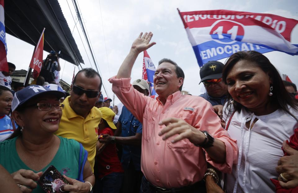 In this April 14, 2019 photo, Presidential candidate Laurentino Cortizo, center, of the Democratic Revolutionary Party (PRD), waves to supporters during a campaign rally in Arraijan, Panama. Panama will hold general elections on May 5. (AP Photo/Arnulfo Franco)