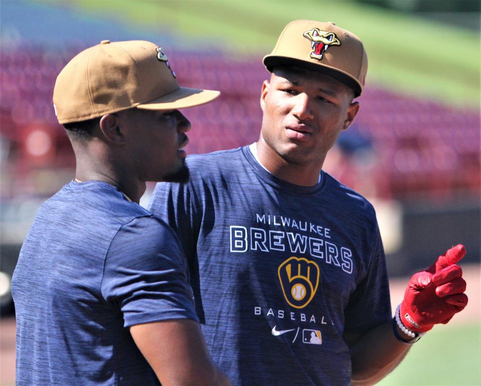 Milwaukee Brewers prospect Jackson Chourio talks with a teammate during batting practice prior to his debut with the Wisconsin Timber Rattlers on July 26, 2022.