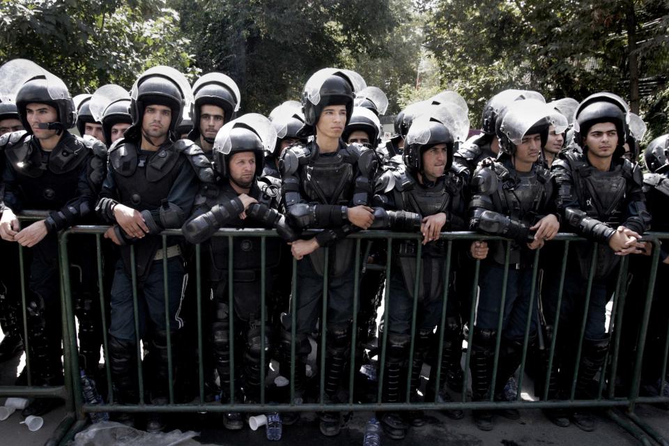 Iranian police officers stand guard in front of the Swiss Embassy in Tehran, which represents US interests in Iran, during a demonstration against a film ridiculing Islam's Prophet Muhammad, Thursday, Sept. 13, 2012. The search for those behind the provocative anti-Muslim film led Wednesday to a California Coptic Christian convicted of financial crimes who acknowledged his role in managing and providing logistics for the production. Nakoula Basseley Nakoula, 55, told The Associated Press in an interview outside Los Angeles that he was manager for the company that produced