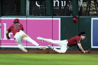 Arizona Diamondbacks right fielder Jake McCarthy (31) makes a catch on a fly ball hit by St. Louis Cardinals' Willson Contreras as McCarthy collides with Diamondbacks center fielder Corbin Carroll, right, during the sixth inning of a baseball game, Sunday, April 14, 2024, in Phoenix. (AP Photo/Ross D. Franklin)