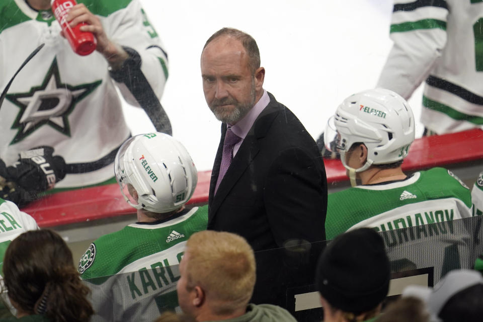 FILE -Dallas Stars coach Pete DeBoer looks back during the first period of the team's NHL hockey game against the Minnesota Wild, Friday, Feb. 17, 2023, in St. Paul, Minn. Boston's Jim Montgomery, Dallas' Pete DeBoer and Vegas' Bruce Cassidy led their teams to the NHL playoffs this season. Montgomery replaced Cassidy and Cassidy replaced DeBoer. (AP Photo/Abbie Parr, File)