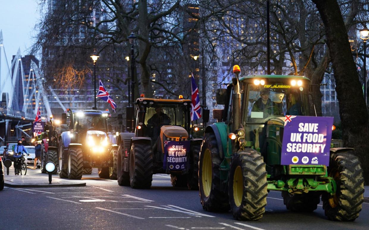 Farmers fly Union flags as they drive during the "go-slow" protest