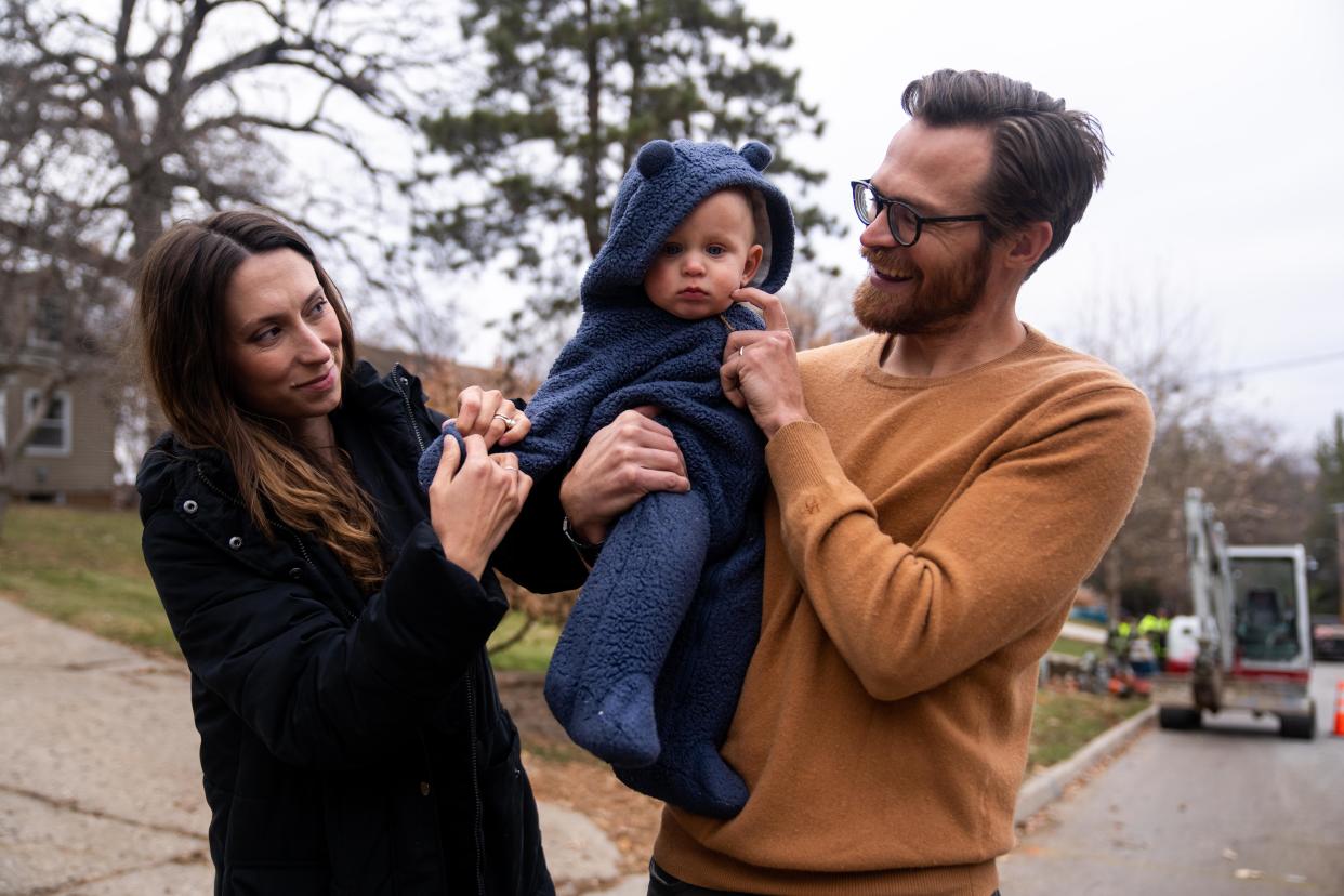 From left to right: Emily, Paul and Michael Donlin take a walk outside their home Tuesday, Dec. 5, 2023, in Des Moines.