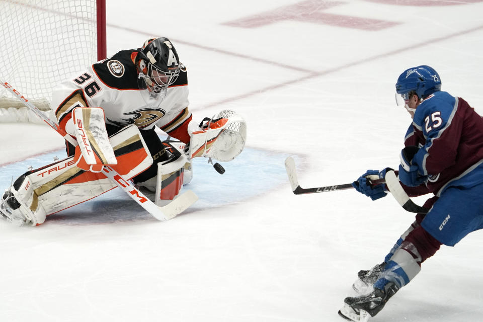 Anaheim Ducks goaltender John Gibson, left, stops a shot by Colorado Avalanche right wing Logan O'Connor during the third period of an NHL hockey game Wednesday, Jan. 19, 2022, in Anaheim, Calif. (AP Photo/Mark J. Terrill)