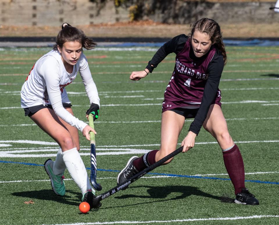 Mamaroneck's Ruby Pearson carries the ball as Orchard Park's Grace McCormick (r) tries to take it away during Mamaroneck's 4-0 win in the New York State Class A Field Hockey championship at Centereach High School on Long Island Nov. 12, 2023.