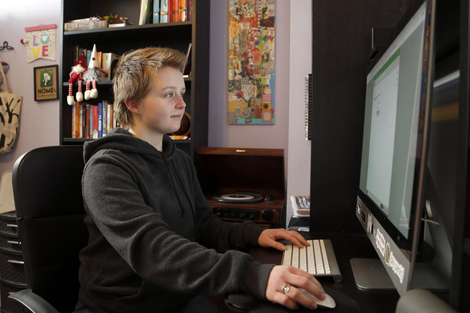 Graciela Leahy, de 13 años, estudiante de octavo grado de la Columbus Gifted Academy, en Columbus, Ohio, trabaja en su computadora en casa el 23 de febrero del 2021. Un año después, el experimento de enseñanza a distancia forzado por la pandemia continua para miles de estudiantes que aún no han regresado a las aulas. (AP Foto/Jay LaPrete)