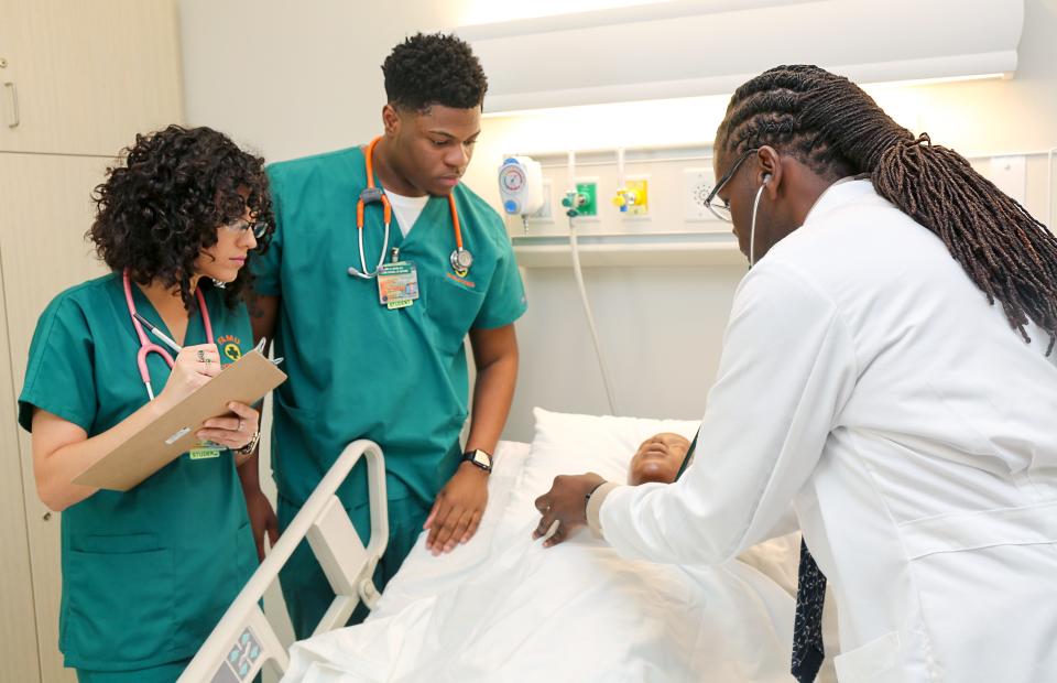 Florida A&M University students make observations and work in the FAMU School of Nursing's simulation lab.