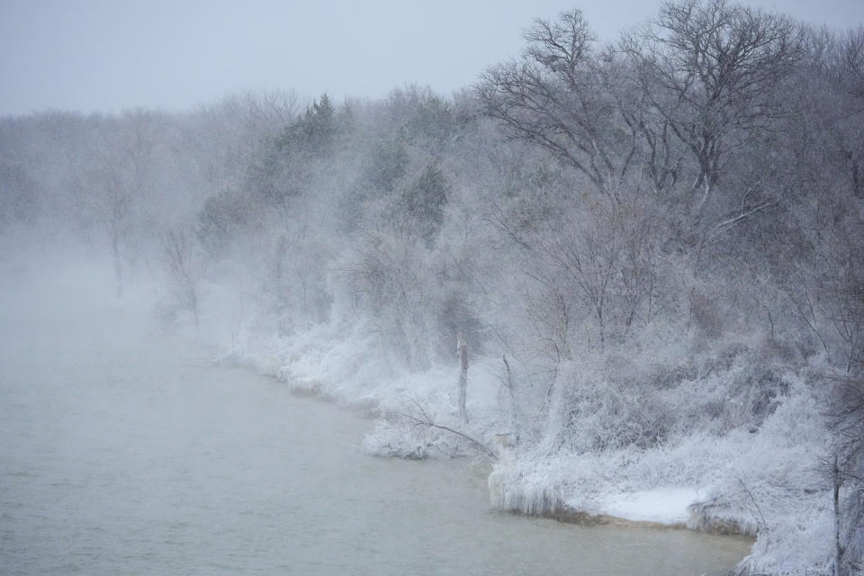 Snow covers the shore of Joe Pool Lake during a winter storm, Monday, Jan. 15, 2024, in Grand Prairie, Texas. (AP Photo/Julio Cortez)