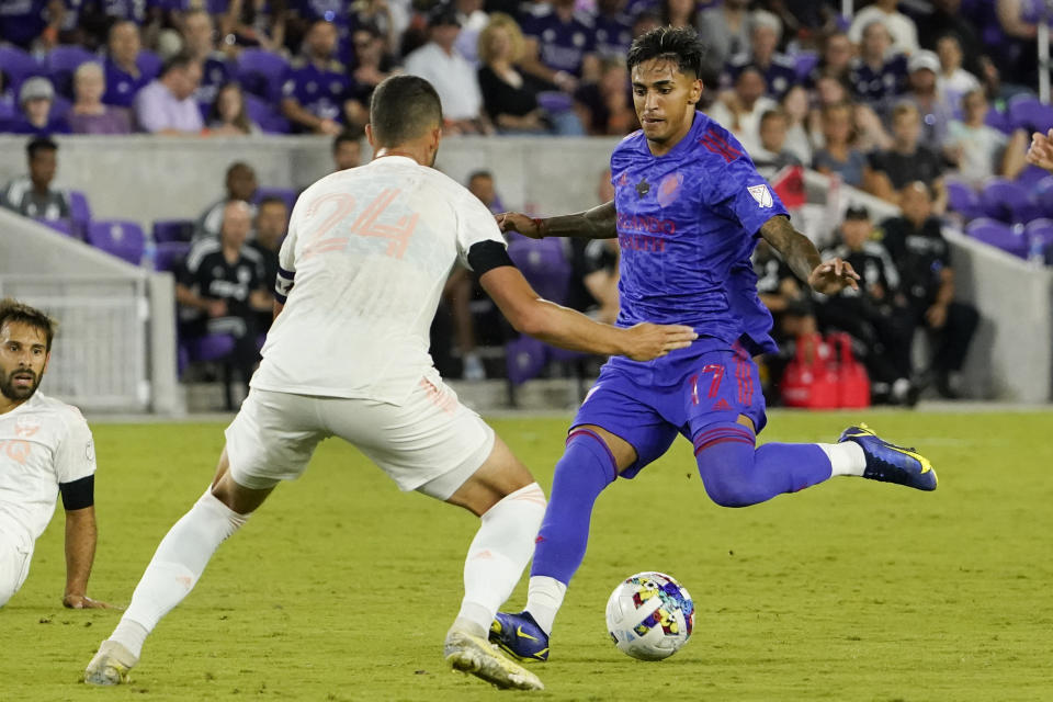 Orlando City forward Facundo Torres, right, attempts a shot as FC Dallas defender Matt Hedges (24) defends during the second half of an MLS soccer match, Saturday, May 28, 2022, in Orlando, Fla. (AP Photo/John Raoux)