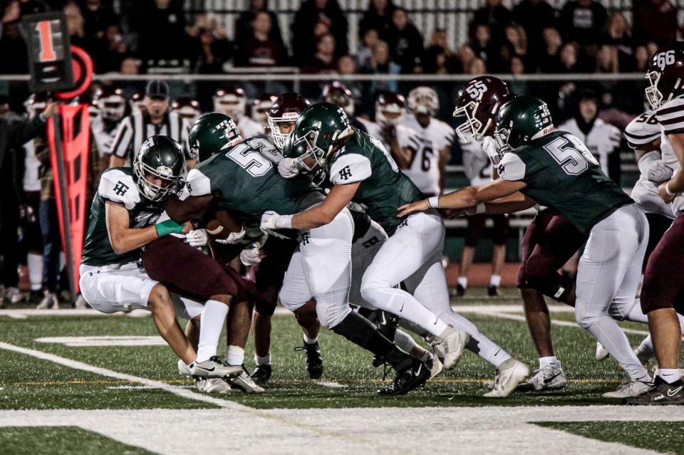 Tower Hill's Brian Adderley (52) and Justin Solacoff (72) make the tackle in Tower Hill's 24-0 home win over Concord at DeGroat Field in Wilmington, Friday, September, 22