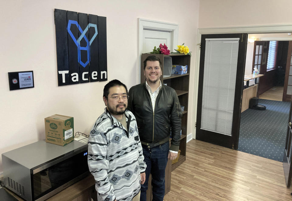 Tacen CEO Jae Yang, left, and company attorney John Bugnacki are seen Monday, Nov. 28, 2022, inside the Cheyenne, Wyo. headquarters of the cryptocurrency exchange planned to launch in 2023. Wyoming has sought with several new laws to attract crypto-related businesses to the state and plans to keep doing so despite the industry's recent troubles. (AP Photo/Mead Gruver)