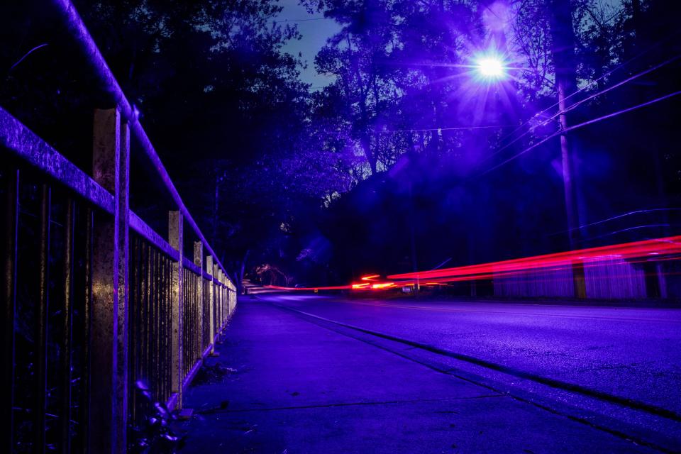 A blue street light on Centerville Road illuminates the pavement as cars drive by Monday, March 21, 2022.