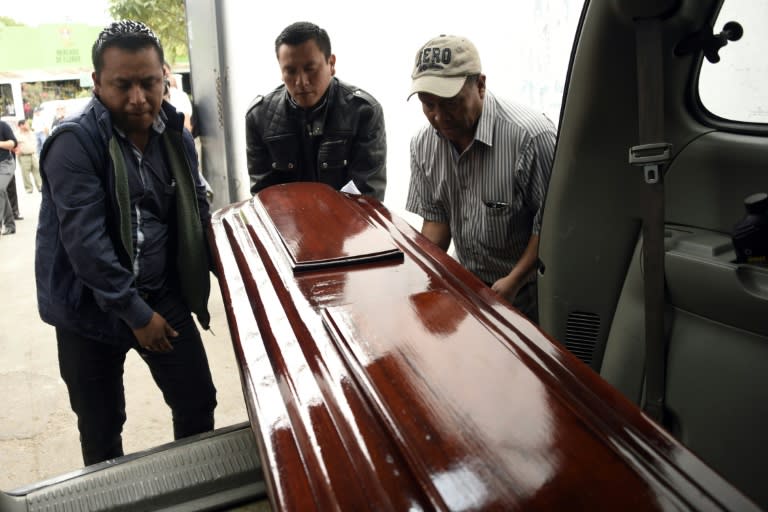 Workers carry the coffin of Keyla Salguero, one of the victims of a fire at a government-run children's shelter in San Jose Pinula, east of Guatemala City