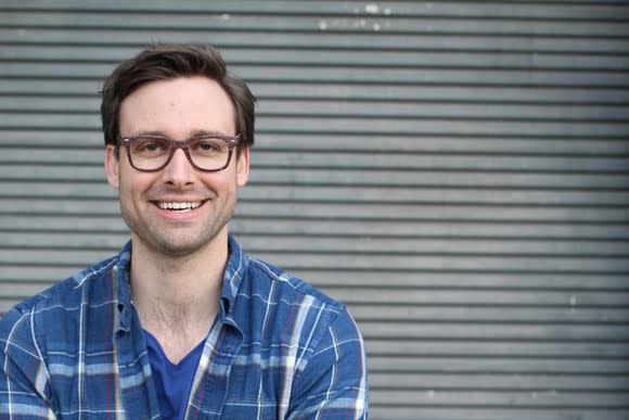 Smiling man with glasses in plaid shirt