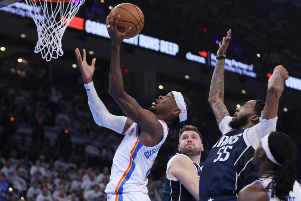 Oklahoma City Thunder guard Shai Gilgeous-Alexander (2) goes to the basket past Dallas Mavericks forward Derrick Jones Jr. (55) and guard Luka Doncic (77) during Game 1 of the Western Conference semifinals NBA playoff game between the Oklahoma City Thunder and the Dallas Mavericks at Paycom Center in Oklahoma City, Tuesday, May 7, 2024. Oklahoma City won 117-95.